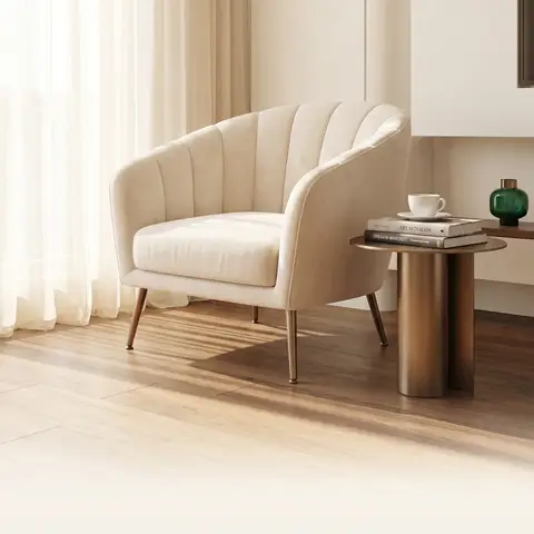 A cream channel-tufted armchair beside a brass side table in soft daylight